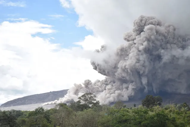 Mount Sinabung on Sumatra island is seen from Karo unleashing gas and fine rock as it erupts again on October 31, 2016. Sinabung roared back to life in 2010 for the first time in 400 years and after another period of inactivity it erupted once more in 2013, and has remained highly active since. (Photo by Satar Ginting/AFP Photo)
