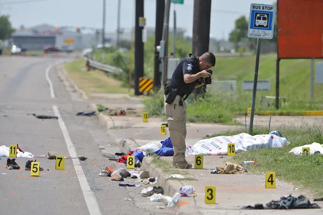 A law enforcement officer photographs the scene after a deadly incident where a car ran into pedestrians near Ozanam Center, a shelter for migrants and homeless, in Brownsville, Texas, U.S. May 7, 2023. (Photo by John Faulk/Reuters)