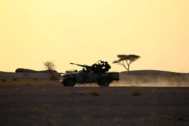 The Polisario Front soldiers drive a pick-up truck mounted with an anti-aircraft weapon during sunset in Bir Lahlou, Western Sahara, September 9, 2016. (Photo by Zohra Bensemra/Reuters)