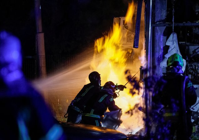 Firefighters work at a site of an apartment building hit by a Russian drone strike in Kyiv, Ukraine on October 29, 2024. (Photo by Gleb Garanich/Reuters)