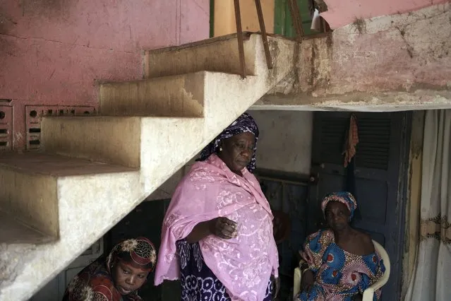 Seynabou Diop, center, stands with her relatives in their home after talking about her son, Khadim Ba, 21, who died during the protests earlier this month in Dakar, Senegal, Thursday, June 15, 2023. “If I had known (he was going to protest), Khadim would never have taken part”, said Diop. “I want (the government) to meet the expectations of young people, the government has an obligation to help (them)”, she said. (Photo by Leo Correa/AP Photo)