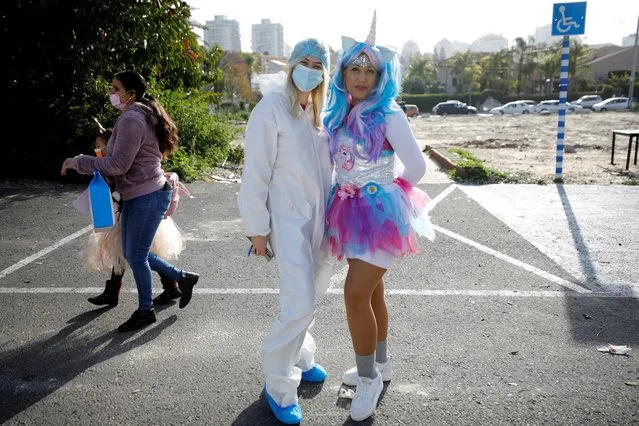 Teachers wearing dress-up costumes to mark the upcoming Jewish holiday of Purim, which is a celebration of the Jews' salvation from genocide in ancient Persia, pose for a picture near their school in Ashkelon, southern Israel on February 24, 2021. (Photo by Amir Cohen/Reuters)