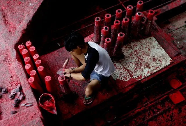 An Indonesian worker prepares candles at a traditional Chinese candle maker for the upcoming Lunar New Year in Bogor, Indonesia, 27 January  2015. (Photo by Adi Weda/EPA)