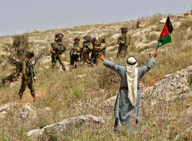 Members of Israeli security forces deploy as Palestinians demonstrate against the establishment of Israeli outposts on their lands, in Beit Dajan east of Nablus in the occupied West Bank, on April 29, 2022. (Photo by Jaafar Ashtiyeh/AFP Photo)