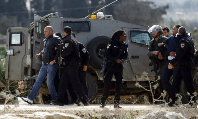 Israeli police detain Palestinian protesters during a protest against what Palestinians say is land confiscation for Jewish settlements, in the West Bank village of Silwad near Ramallah February 9, 2015. (Photo by Mohamad Torokman/Reuters)