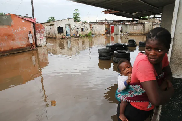 Flooded street in a Luanda neighborhood following the heavy rains that fell on 19 April that caused the death of 14 people and flooded mor​e than 16,000 houses, Luanda, Angola, 20 April 2021. (Photo by Ampe Rogerio/EPA/EFE)