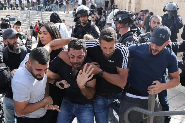 A Palestinian man reacts as he is detained by undercover Israeli security force members amid Israeli-Palestinian tension as Israel marks Jerusalem Day, at Damascus Gate just outside Jerusalem's Old City on May 10, 2021. (Photo by Ronen Zvulun/Reuters)