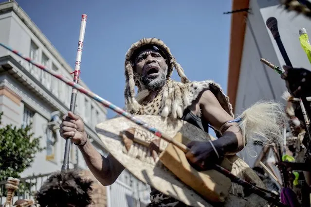 A traditionally dressed Zulu man dances during a gathering in front of a morgue in Johannesburg CBD, on May 5, 2021, to pay his last respects to Zulu Queen Shiyiwe Mantfombi Dlamini Zulu who died on April 29, 2021, just a month after she became regent. (Photo by Luca Sola/AFP Photo)