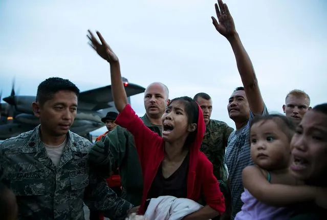 Emotions run high as loved ones are split apart  boarding aircraft during the evacuation of hundreds of survivors in Tacloban. (Photo by Paula Bronstein/Getty Images)