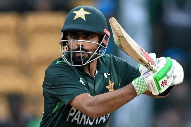 Pakistan's captain Babar Azam plays a shot during the 2023 ICC Men's Cricket World Cup one-day international (ODI) match between New Zealand and Pakistan at the M. Chinnaswamy Stadium in Bengaluru on November 4, 2023. (Photo by Sajjad Hussain/AFP Photo)
