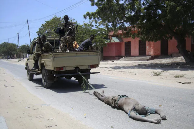 Although al Shabaab have still struck back repeatedly with bombs and attacks, their retreat from Mogadishu and Kismayu signaled they could not defeat militarily a government backed by foreign firepower. Here: Somali government soldiers drag the body of an al Shabaab fighter killed during fights south of Mogadishu August 24, 2010. (Photo by Feisal Omar/Reuters)