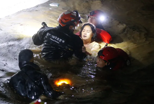 Firefighters and military officials rescue one of the missing residents from the underground parking lot of an apartment building in Nam-gu, Pohang-si, Gyeongsangbuk-do, which was submerged in heavy rain caused by Typhoon Hinnamno in Pohang, South Korea, 07 September 2022. According to fire authorities, two people were rescued alive and three bodies found out of seven people who were reportedly missing in the incident. (Photo by Kim Hee-Chul/EPA/EFE)