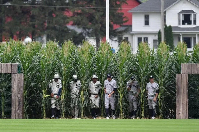 Players emerge from a cornfield to enter the “Field of Dreams” before the MLB game between the Chicago White Sox and the New York Yankees in Dyersville, Iowa, August 12, 2021. The specially constructed field, which seats just 8,000 fans, is located just yards from the actual field used on the set of the 1989 film. (Photo by Jeffrey Becker/USA TODAY Sports)