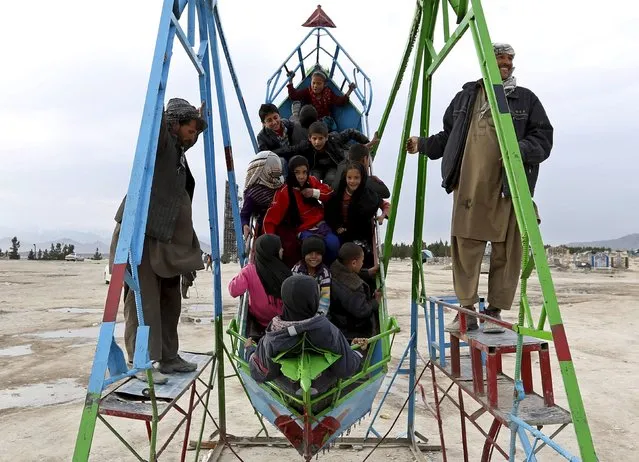 Afghan children enjoy a ride in Kabul on March 30, 2015. (Photo by Mohammad Ismail/Reuters)