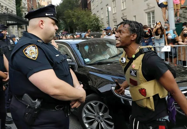 A Black Lives Matter protester (R) screams at New York City police officers outside the Met Gala on Fifth Avenue in New York, Ne​w York, USA, 13 September 2021. (Photo by Peter Foley/EPA/EFE)