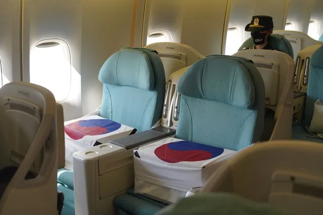 Boxes of two identified remains of South Korean soldiers killed in the 1950-53 Korean War are placed in seats of South Korean President Moon Jae-in's presidential jet at Hickam Air Force Base in Honolulu, Hawaii, USA, 22 September 2021, as South Korea and the United States hold an alliance ceremony to transfer the remains of Korean and American troops killed during the three-year conflict. (Photo by Yonhap/EPA/EFE)