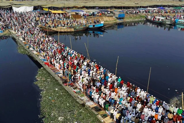 Bangladeshi Muslim pilgrims offer Friday prayers on the first day of the three-day World Congregation of Muslims, or Biswa Ijtema, on the banks of the River Turag in Tongi, 20 kilometers (13 miles) north of the capital Dhaka, Bangladesh, Friday, January 24, 2014. Hundreds of thousands of Muslims join the weekly prayer Friday during the annual three-day event that is one of the world's largest religious gatherings being held since 1960's to revive Islamic tenants. (Photo by A. M. Ahad/AP Photo)
