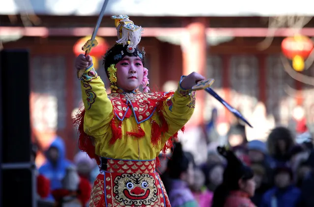 A folk artist performs during a temple fair at Daguanyuan park as the Chinese Lunar New Year, which welcomes the Year of the Rooster, is celebrated in Beijing, China January 30, 2017. (Photo by Jason Lee/Reuters)