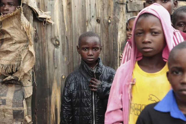 Children stand near a makeshift shelter after a cyclone went through the area in Chimanimani, southeast of Harare, Zimbabwe, Monday, March 18, 2019. (Photo by Tsvangirayi Mukwazhi/AP Photo)