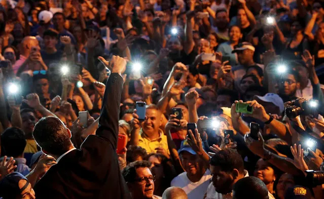 Venezuelan opposition leader Juan Guaido, who many nations have recognized as the country's rightful interim ruler, gives a thumbs up to supporters in Caracas, Venezuela, Venezuela, March 28, 2019. (Photo by Carlos Garcia Rawlins/Reuters)