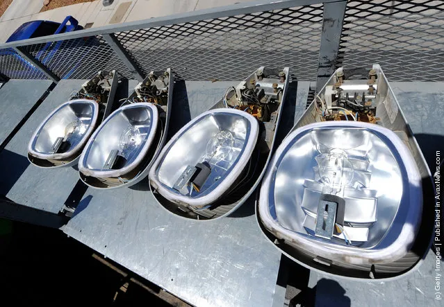 Old street lights are stacked on a truck after being removed and replaced with new LED light fixtures