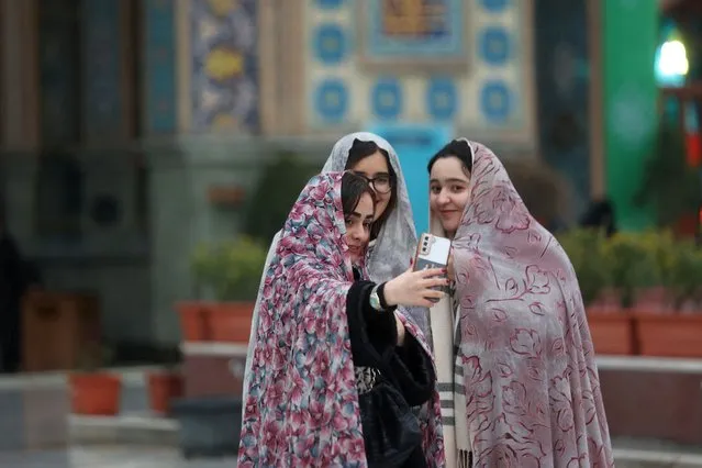 Iranian women take a selfie in the Imamzadeh Saleh shrine during the month of Ramadan in Tehran, Iran, on March 11, 2024. (Phoot by Majid Asgaripour/WANA)
