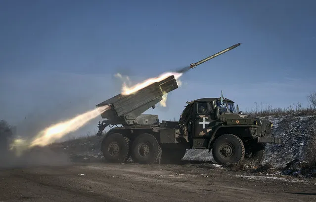 Ukrainian army Grad multiple rocket launcher fires rockets at Russian positions in the frontline near Soledar, Donetsk region, Ukraine, Wednesday, January 11, 2023. (Photo by Libkos/AP Photo)