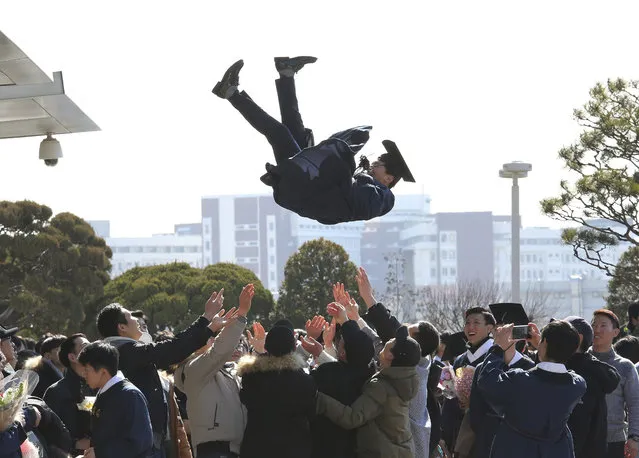 A South Korean graduate is thrown into the air during a graduation ceremony at Sungkyunkwan University in Seoul, South Korea, Friday, February 24, 2017. (Photo by Ahn Young-joon/AP Photo)