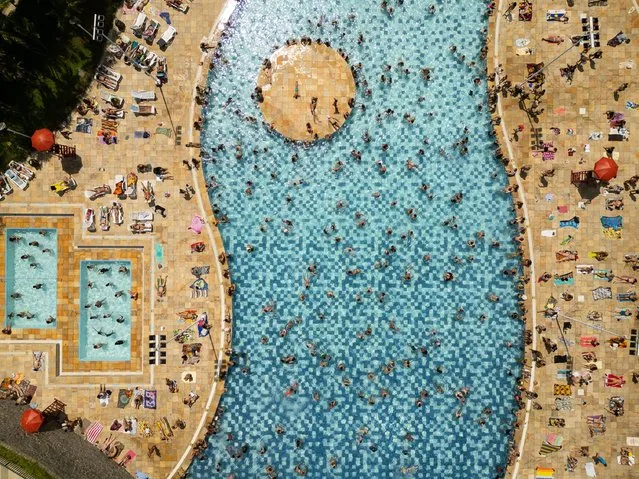 An aerial photo taken with a drone shows bathers at the Sesc Belenzinho swimming pools east of the city of Sao Paulo, Brazil, 16 March 2024. People flocked to the pools seeking relief from the heatwave that hit Brazil on the last weekend of summer. (Photo by Isaac Fontana/EPA)