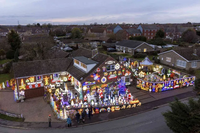 A Christmas light display in Soham, Cambridgeshire, England, at the home of Helen and John Attlesey who have decorated their house to raise money for East Anglia's Children's Hospices, Sunday, November 28, 2021. (Photo by Joe Giddens/PA Wire via AP Photo)