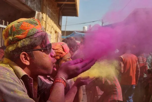 Men blow coloured powder during Holi celebrations in the town of Barsana in the state of Uttar Pradesh, India, March 6, 2017. (Photo by Cathal McNaughton/Reuters)