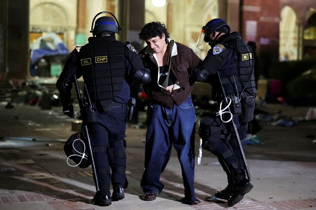 Law enforcement officers detain a protester at the University of California Los Angeles (UCLA), during a pro-Palestinian protest, in Los Angeles, California on May 2, 2024. (Photo by Mike Blake/Reuters)