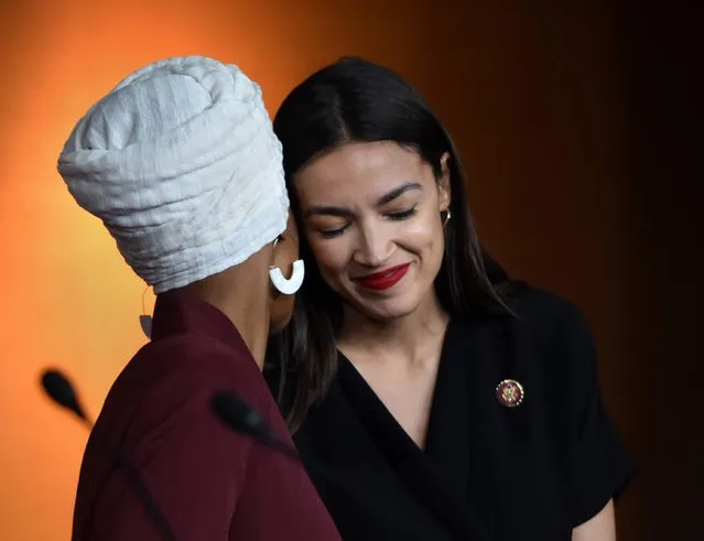 U.S. Rep. Alexandria Ocasio-Cortez (D-NY) right, embraces Rep. Ilhan Omar (D-MN). Four Democratic progressive Congresswomen make a statement during a press conference at the U.S. Capitol on July 15, 2019 in Washington, DC about President Trump's remarks telling them to “ego back” to their home countries which they deemed “eblatantly racist” attacks. (Photo by Carol Guzy/Imago Images/ZUMA Press)
