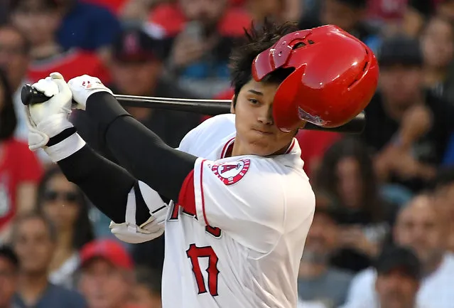 Los Angeles Angels designated hitter Shohei Ohtani (17) loses his batting helmet while swinging on a foul ball against the Houston Astros in the first inning at Angel Stadium of Anaheim in Anaheim, CA, USA on July 15, 2019. (Photo by Jayne Kamin-Oncea/USA TODAY Sports)