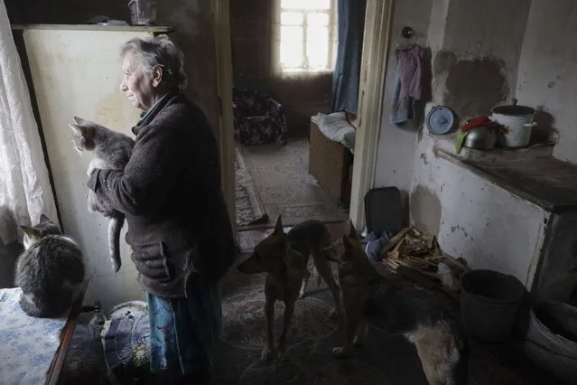 Local inhabitant Natalia (63) with her pets stands inside of her home in the Avdiivka village, not far from pro-Russian militants controlled city Donetsk, Ukraine, 26 January 2022. Natalia lives a few kilometers from the front line and was heavily injured during a battle escalation in January of 2017. The United States assumes that Russia will try to invade Ukraine before mid-February. This was stated by US Deputy Secretary of State Wendy Sherman in a conversation with Former Estonian President Kersti Kaljulaid as part of the YES (Yalta European Strategy) online discussion on 26 January 2022. (Photo by Stas Kozlyuk/EPA/EFE)