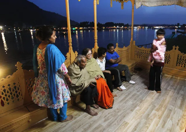 Indian tourists enjoy an evening on the deck of a houseboat in Srinagar June 8, 2012. (Photo by Fayaz Kabli/Reuters)