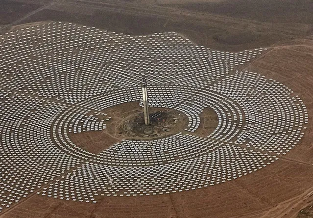 Aerial view of the Noor 3 solar power station which is nearing completion, near Ouarzazate, southern Morocco, Saturday, April. 1, 2017. The king unveiled one of the world's biggest solar plants, taking advantage of the Sahara sunshine and a growing global push for renewable energy. (Photo by Abdeljalil Bounhar/AP Photo)