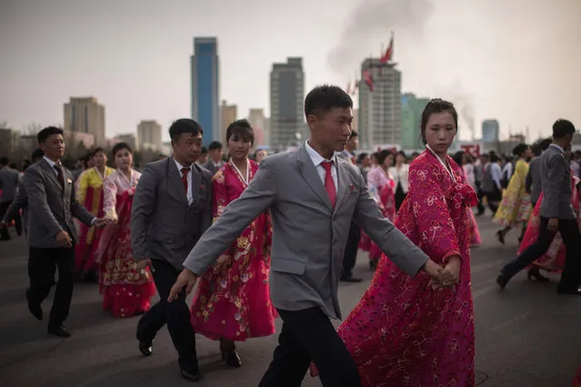 North Korean students take part in a mass dance event in Pyongyang on April 9, 2017 The event was held to mark the election of late North Korean leader Kim Jong- Il' s “election to the National Defence Committee” in 1993. Mass dance events are frequently held on anniversaries and dates of importance on the North Korean calendar, and are a regular fixture on tourist itineraries. (Photo by Ed Jones/AFP Photo)