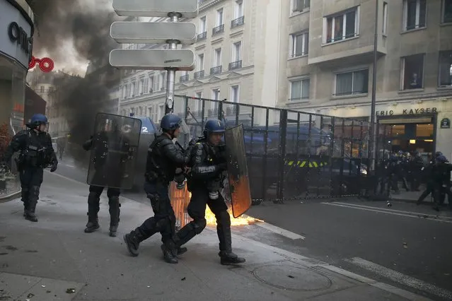 French riot police gather during clashes with protestors during a demonstration against French labour law reform in Paris, France, May 12, 2016. (Photo by Gonzalo Fuentes/Reuters)