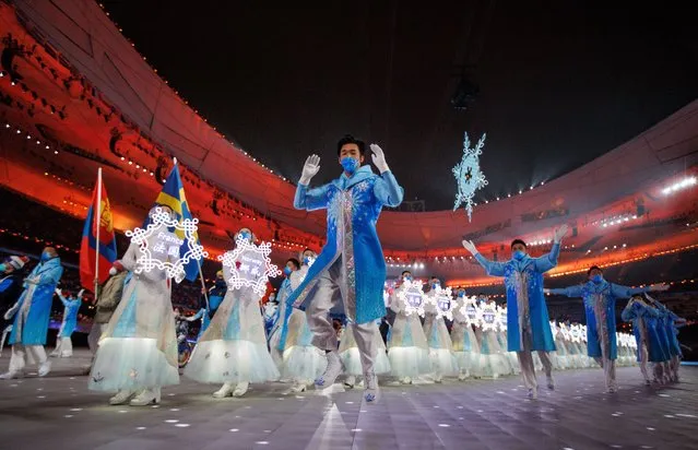 A handout photo made available by OIS/IOC shows volunteers on stage with the country snowflakes during the parade of athletesduring the 2022 Winter Paralympic Games closing ceremony at the National Stadium in Beijing, China, 13 March 2022. (Photo by Chloe Knott/EPA/EFE)
