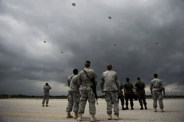 A US army soldiers of the second Squadron 28th Cavalry Regiment (2-38th) part of the NATO-led peacekeeping mission in Kosovo jump with parachutes during a US military drill near the town of Gjakova on May 12, 2014. (Photo by Armend Nimani/AFP Photo)