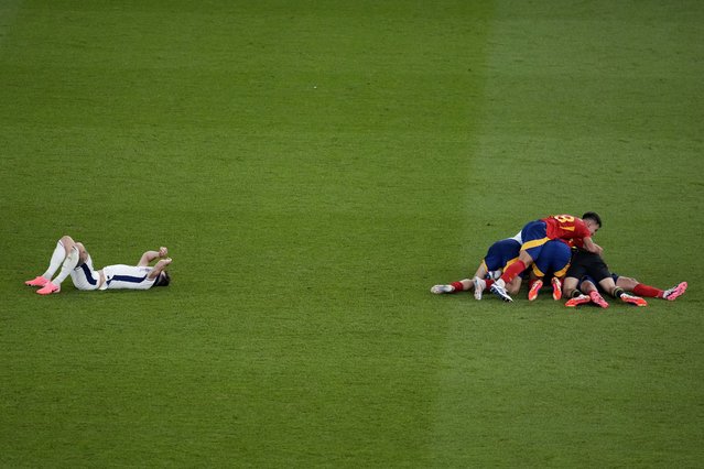 Spain's players celebrate after their team defeated England 2-1 in the final match at the Euro 2024 soccer tournament in Berlin, Germany, Sunday, July 14, 2024. (Photo by Thanassis Stavrakis/AP Photo)