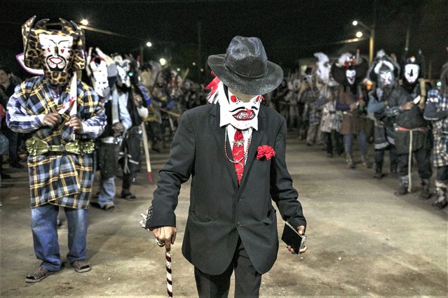 Villagers wearing costumes take part in a Holy Thursday local celebration in the town of Santa Rosalia, in the municipality of Mulege, Baja California Sur state, Thursday, April 6, 2023. (Photo by Emilio Espejel/AP Photo)