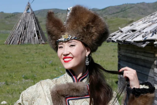 A model of the “Altyr” fashion theatre, dressed in a Khakas national costume, poses during a photo session, as a part of the rehearsal for the Tun-Pairam traditional holiday (The Holiday of the First Milk ) celebration at a museum preserve outside Kazanovka village near Abakan in the Republic of Khakassia, Russia, May 28, 2016. (Photo by Ilya Naymushin/Reuters)