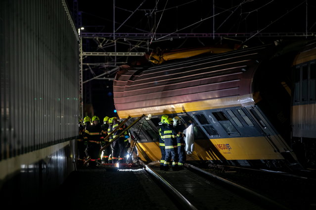 Firefighters work in the aftermath of a train crash in the city of Pardubice, Czech Republic, 05 June 2024. An express train and a freight train collided head-on in Pardubice late 05 June evening. According to a spokeswoman for the Pardubice rescue service, Alena Kisial, four people have died at the scene, Czech Television is reporting. Dozens of people have been injured, some seriously. More than 300 people were travelling on the passenger train. (Photo by Jiri Sejkora/EPA)