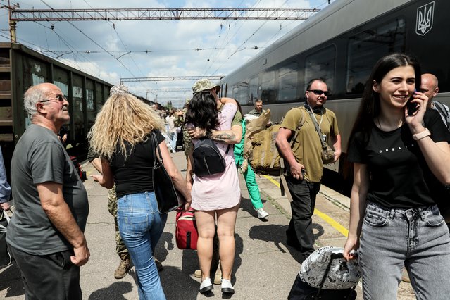 A couple (C) meets at the railway station in Kramatorsk, Donetsk region, Ukraine, 28 May 2023. Under martial law, Ukrainian servicemen are entitled to 10 days of vacation per year. Some of their family members travel to areas closer to the frontline to make the most out of the short time they have available to spend with servicemen, while they’re on a rotational leave. Russian troops entered Ukraine in February 2022, starting a conflict that has provoked destruction and a humanitarian crisis. (Photo by Oleg Petrasyuk/EPA/EFE)