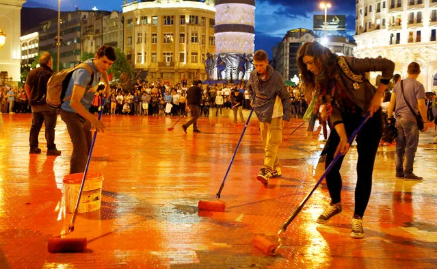 Protesters disperse color paint during a protest against the government, at central square in Skopje, Macedonia, June 6, 2016. (Photo by Ognen Teofilovski/Reuters)