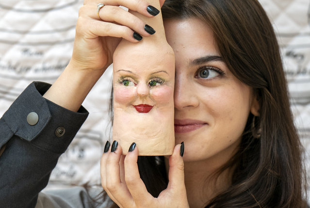 Art graduate Katie Mills with her one of her “Kheeky” face flesh bottles that forms part of her “Bottoms Up” illustration design work during the media preview of the Edinburgh College of Art graduate show in Edinburgh on Friday, August 16, 2024. The exhibition features the work of more than 350 postgraduate students, and is part of the Edinburgh Art Festival, the UK's largest annual celebration of visual art. (Photo by Jane Barlow/PA Images via Getty Images)