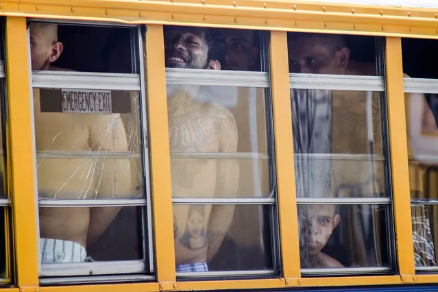 Inmates ride in a bus out of the Cojutepeque prison in El Salvador, Thursday, June 16, 2016. This prison, which houses more than a thousand 18th street imprisoned gang members, will be closed down by the government, since it has been unable to prevent the amount of illegal activities happening inside the prison walls. Inmates will be relocated to other medium-security prisons. (Photo by Salvador Melendez/AP Photo)