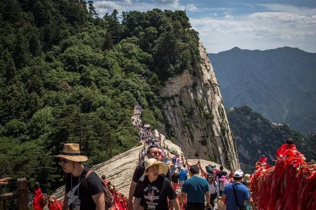 Tourists visit the West Peak of Huashan Mountain, near the city of Huayin, China, 24 June 2017 (issued 26 June 2017). Huashan Mountain is one of the five sacred Taoist mountains in China located near the city of Huayin, around 120 km from Xi'an, the capital of Shaanxi Province. The mountain has five main peaks, of which the highest is the South Peak at 2,154 meters. (Photo by Roman Pilipey/EPA)